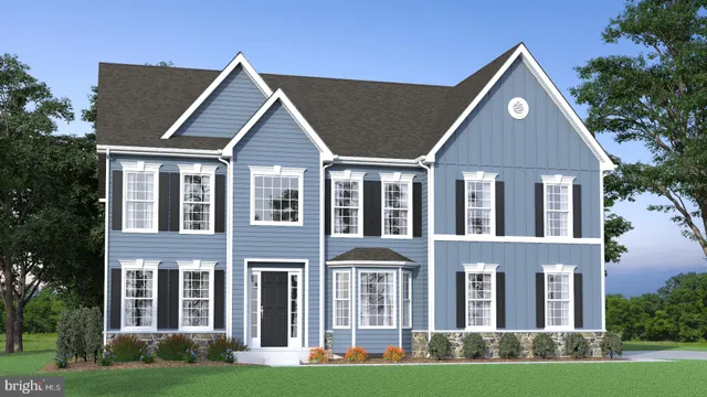 front view of a brick house with a yard