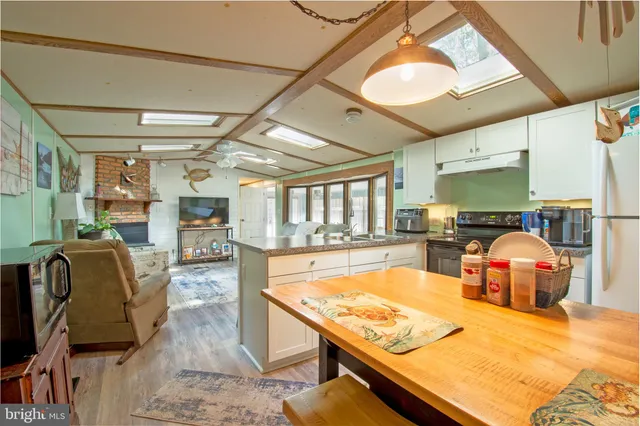 a living room with furniture pool table and chairs