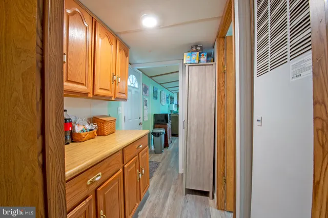a view of a hallway and a dining room with wooden floor