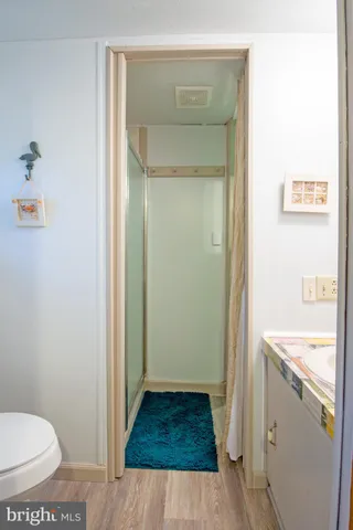 a bathroom with a toilet and a shower