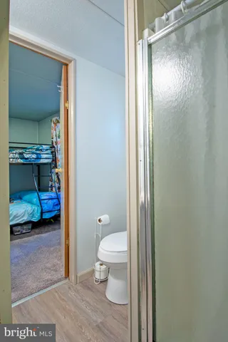 a bathroom with a toilet and a shower