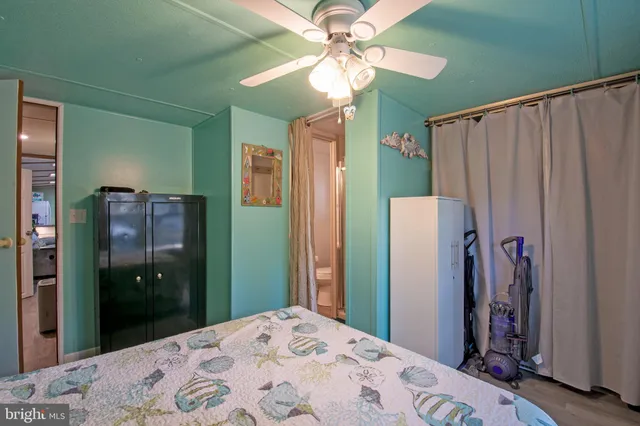 a bedroom with a bed closet and a large mirror