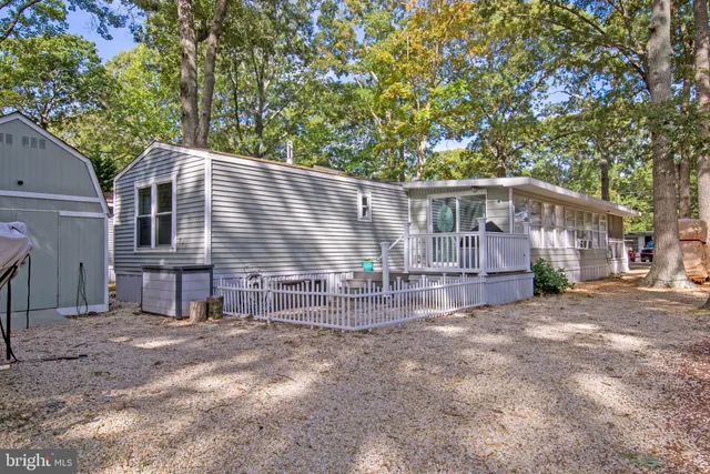a view of a house with a small yard and wooden fence