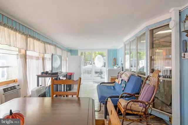 a living room with furniture and large windows