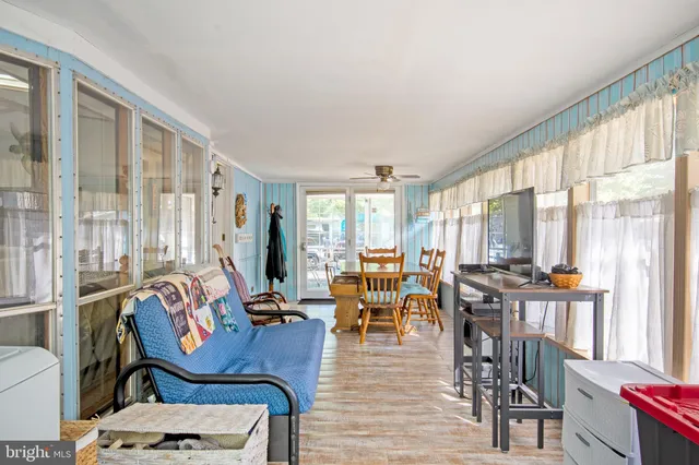 a living room with furniture and large windows