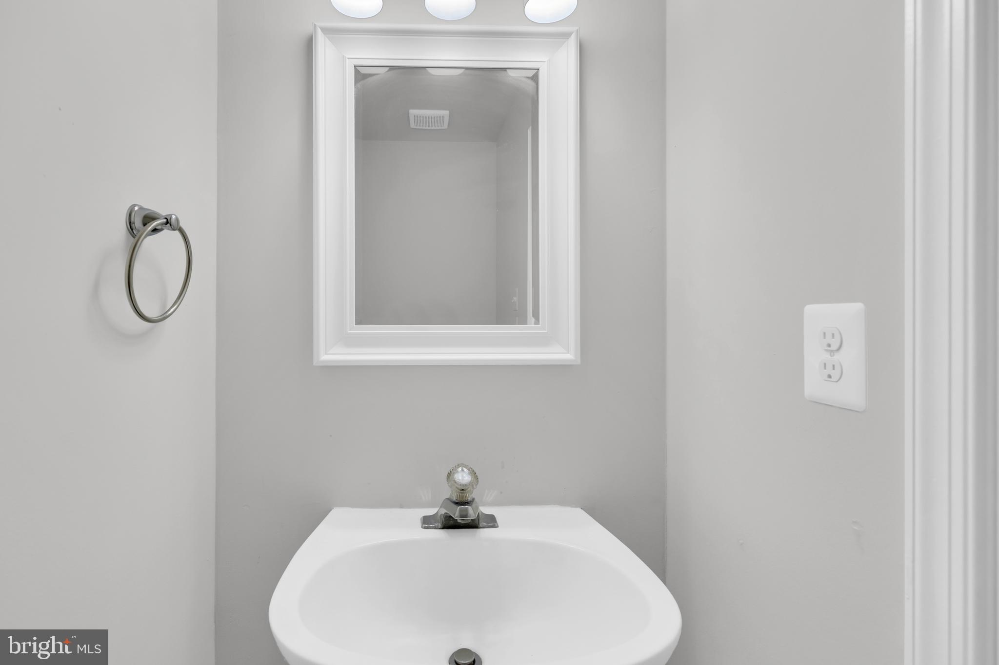 7635 Monitor Court Manassas, VA 20109 - Photo 13 of 46 a bathroom with a sink and mirror