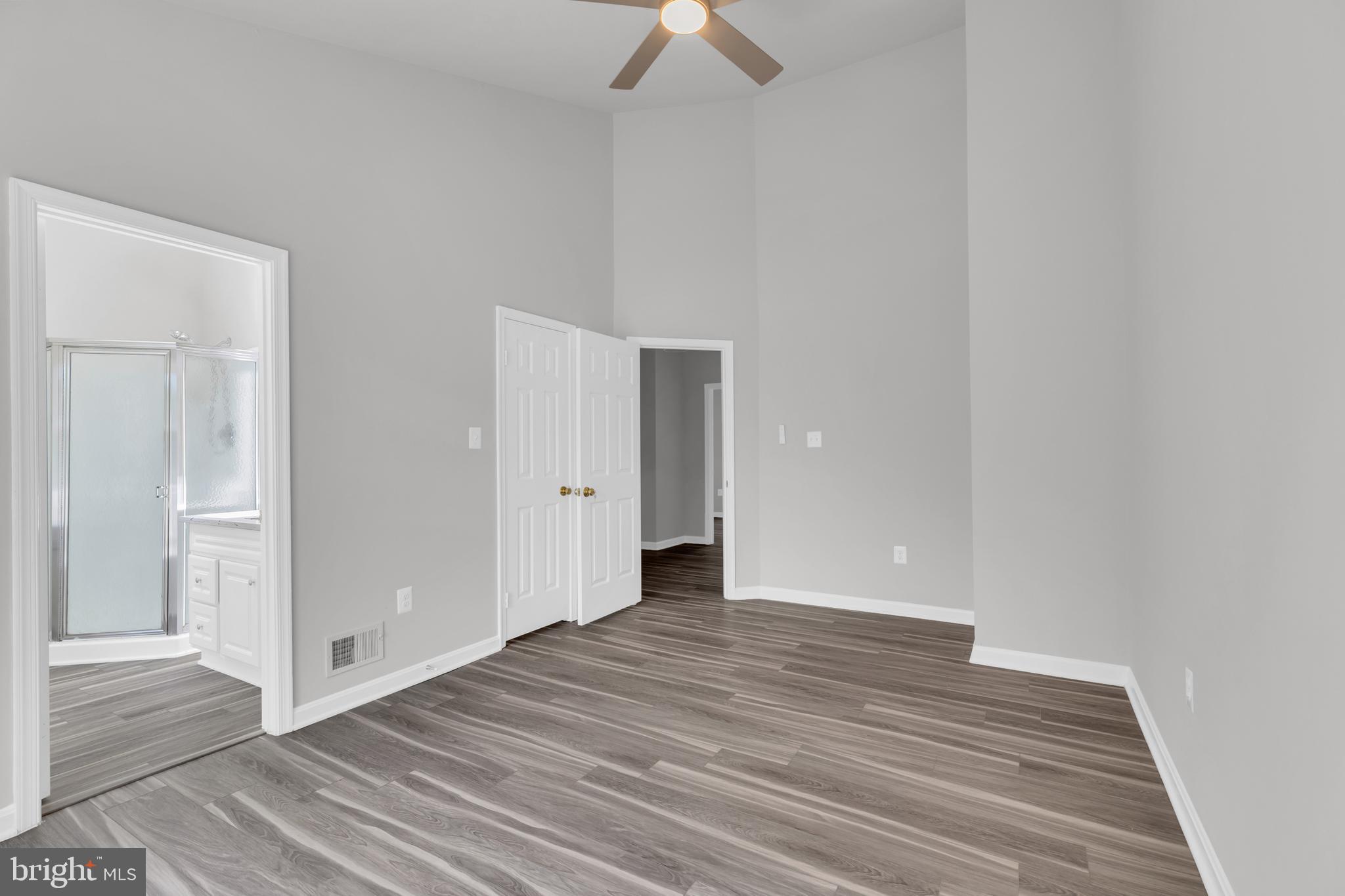 7635 Monitor Court Manassas, VA 20109 - Photo 16 of 46 a view of an empty room with wooden floor and a ceiling fan