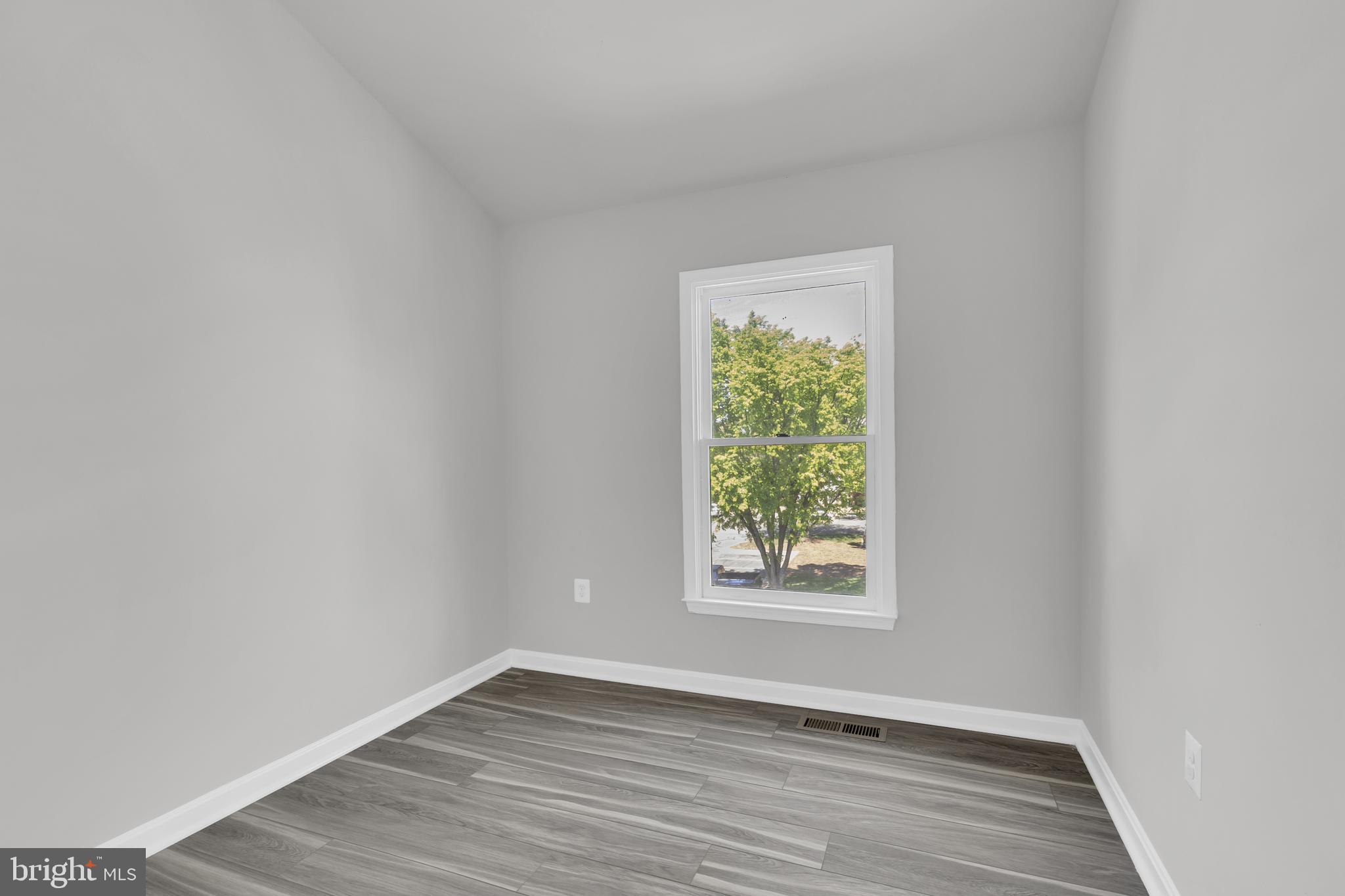 7635 Monitor Court Manassas, VA 20109 - Photo 22 of 46 an empty room with wooden floor and windows