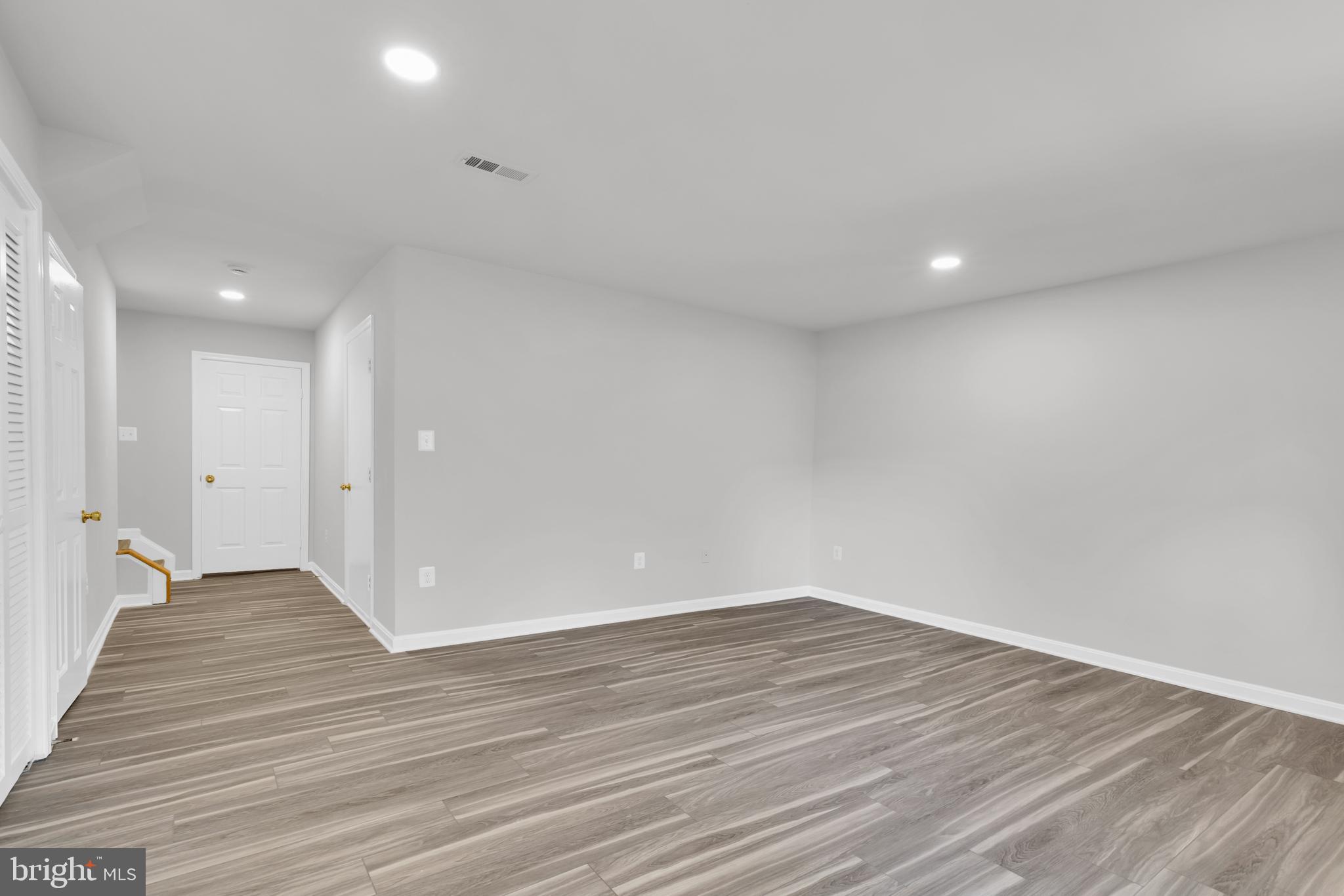 7635 Monitor Court Manassas, VA 20109 - Photo 29 of 46 a view of an empty room with wooden floor