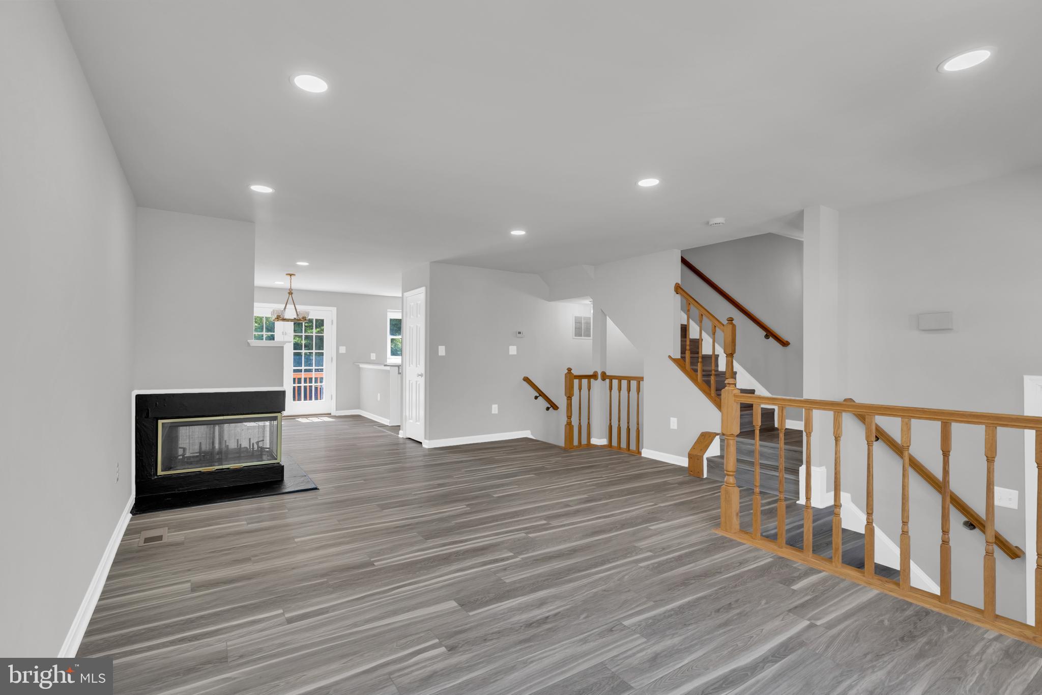 7635 Monitor Court Manassas, VA 20109 - Photo 5 of 46 a hallway with wooden floor fireplace and windows