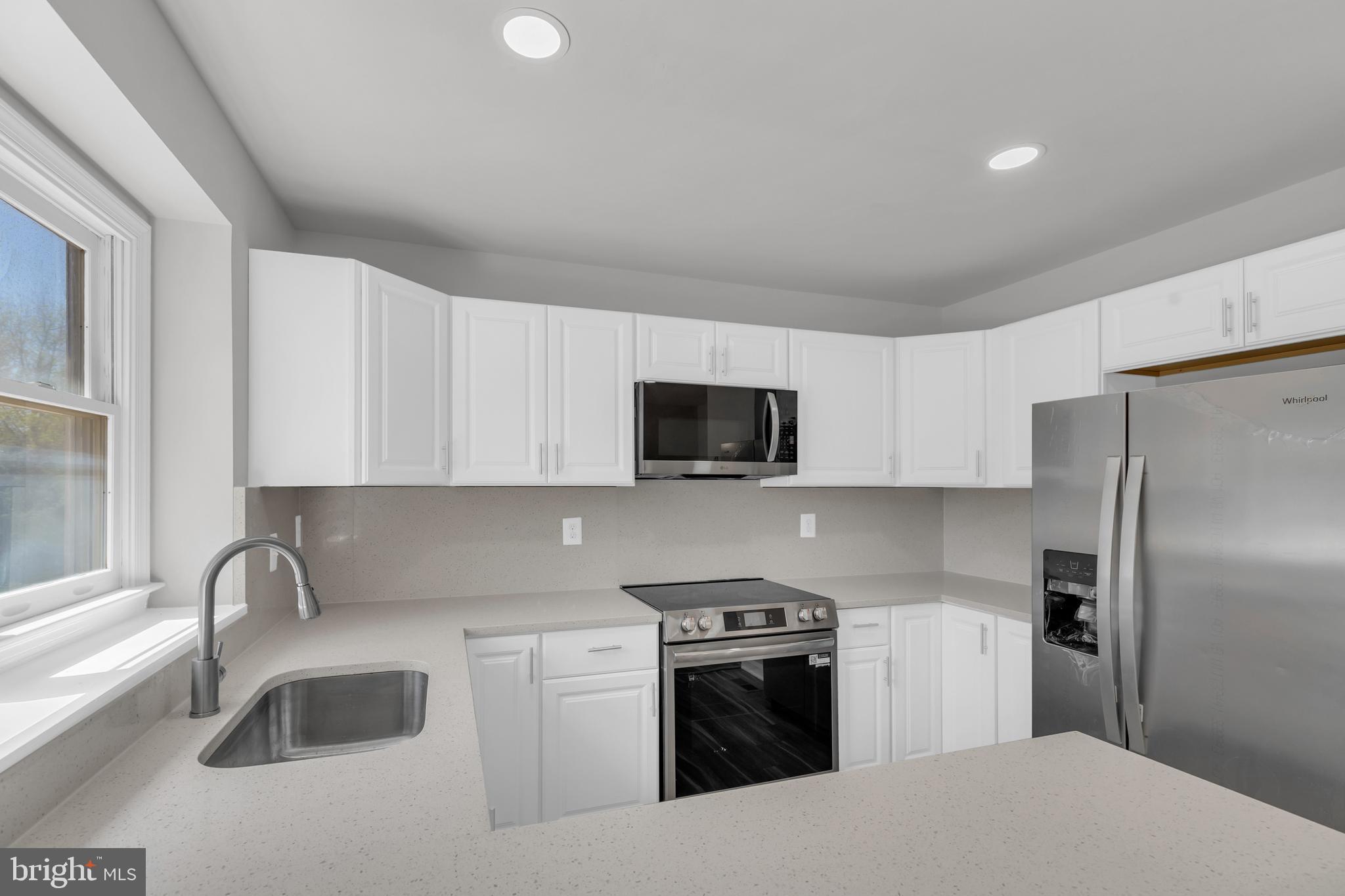 7635 Monitor Court Manassas, VA 20109 - Photo 8 of 46 a kitchen with stainless steel appliances granite countertop a sink stove and refrigerator