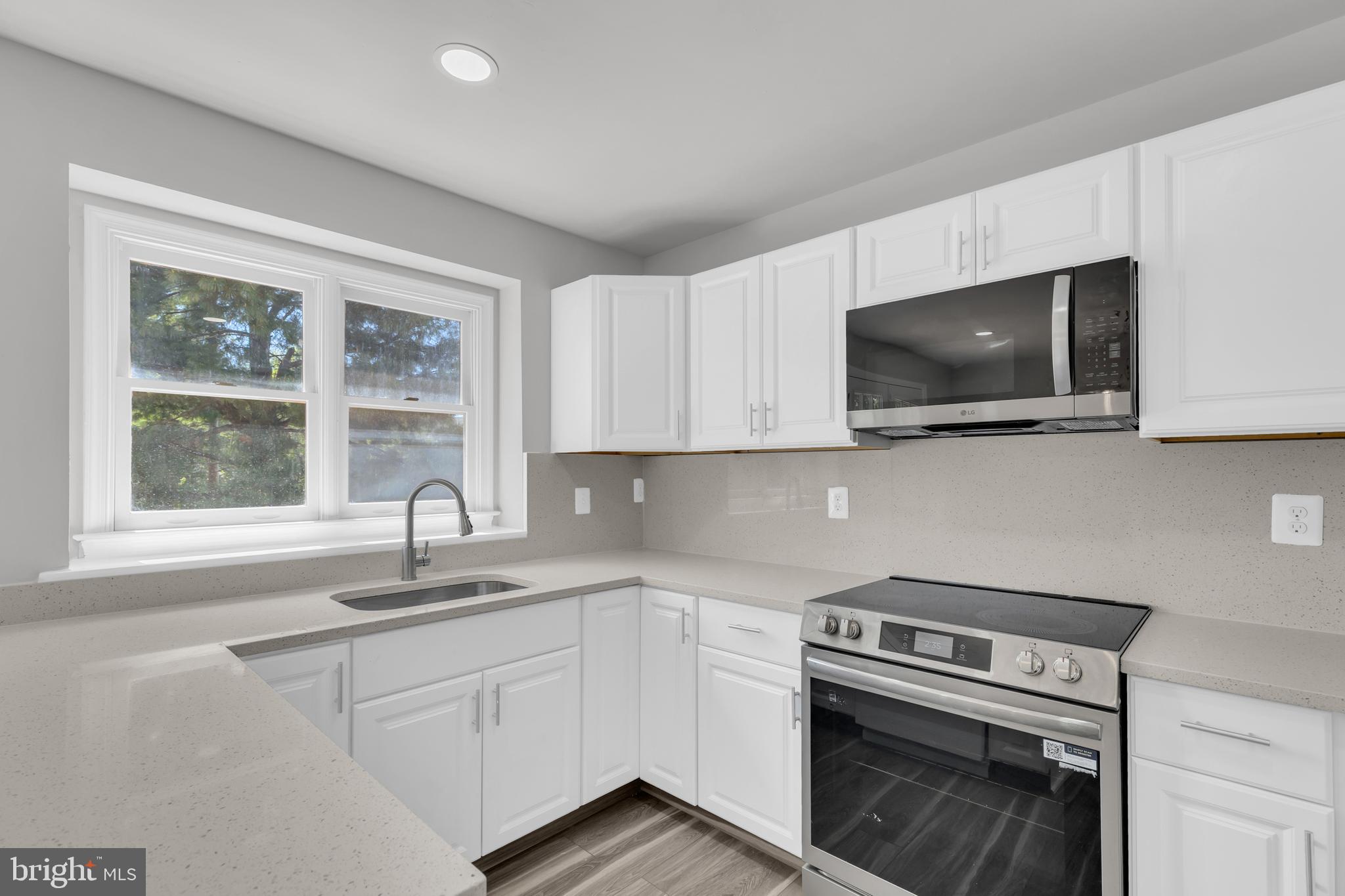 7635 Monitor Court Manassas, VA 20109 - Photo 9 of 46 a kitchen with a sink cabinets and window