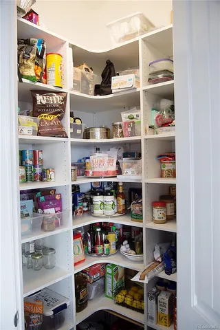 a room with storage and a refrigerator