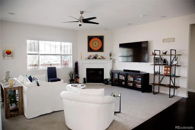 a living room with furniture a fireplace and a flat screen tv