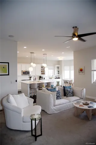 a living room with kitchen island furniture and a kitchen view