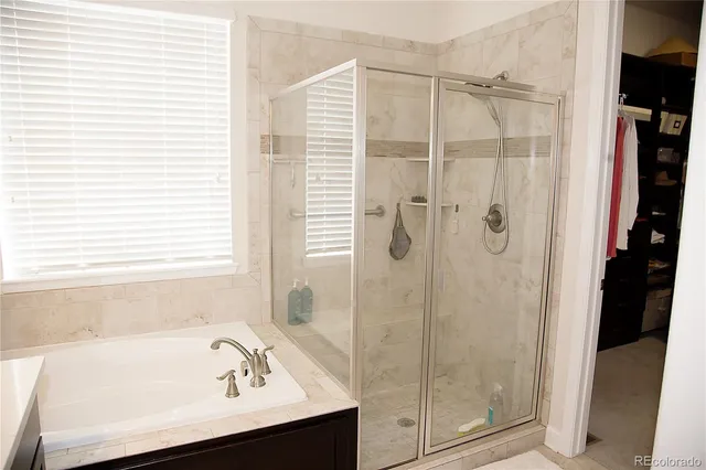 a bathroom with a tub and a shower