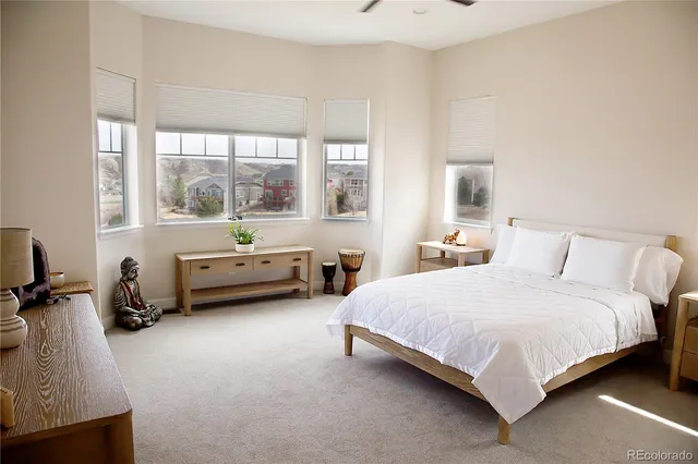 a spacious bedroom with a bed and a couch