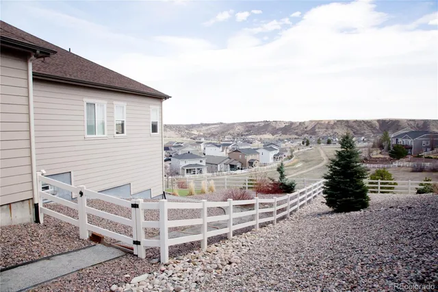 a view of a house with a yard and seating area