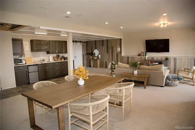 a dining table with chairs and view kitchen