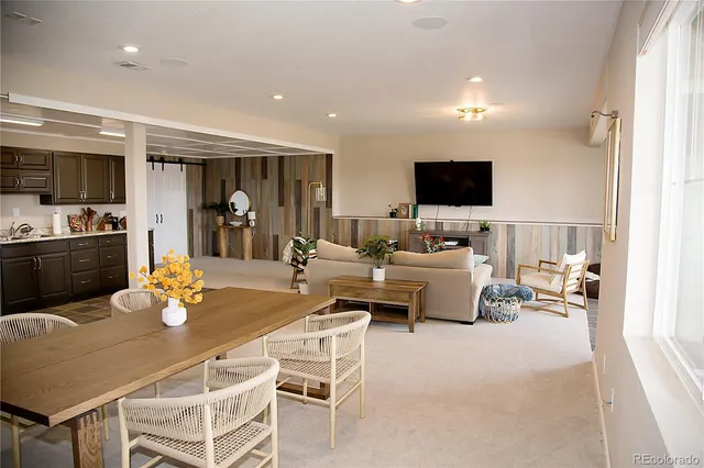 a dining room with furniture and a flat screen tv