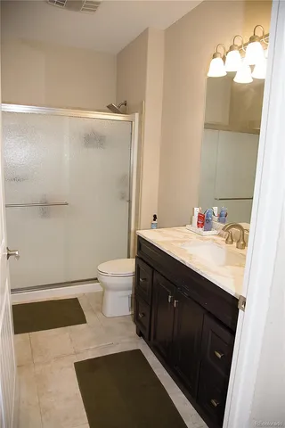 a bathroom with a sink a toilet and a mirror