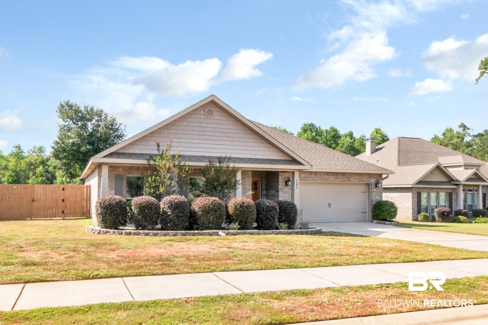 1282 Creek Ridge Court Mobile, AL 36695 - Photo 1 of 33 View of front of house with brick siding, a front lawn, concrete driveway, and an attached garage