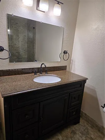 a bathroom with a sink vanity and a mirror