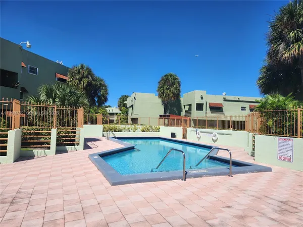 a view of a house with a big yard and large trees