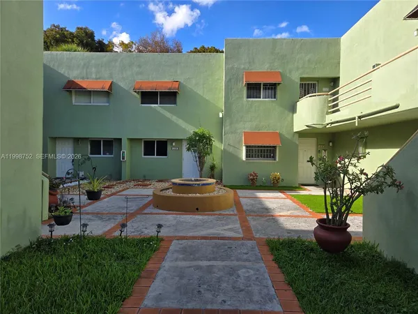 a front view of house and yard with green space