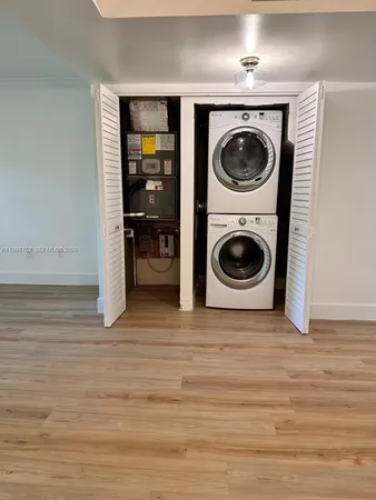 a view of a storage and utility room with washer and dryer