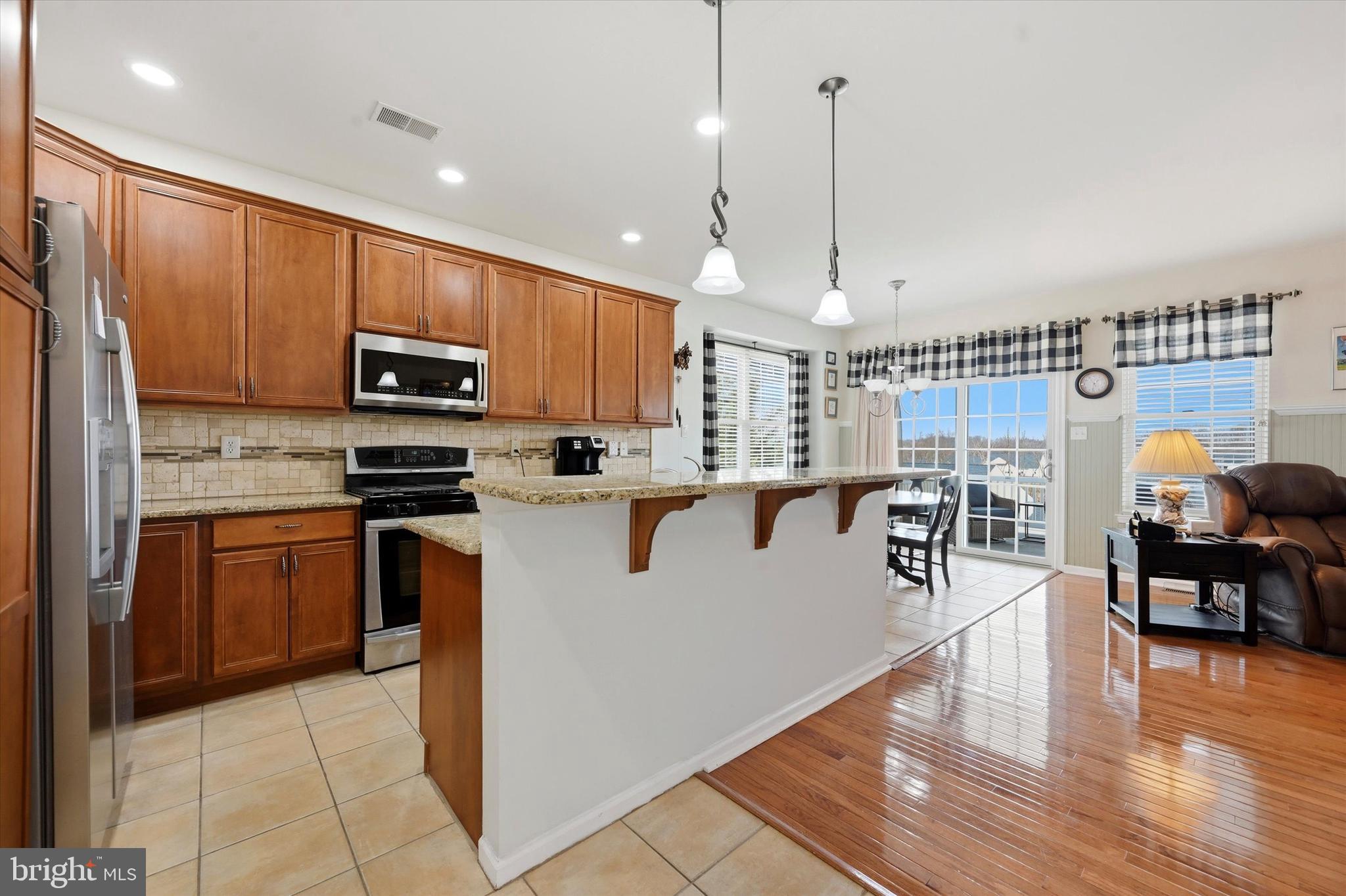 249 Stoyer Road Coatesville, PA 19320 - Photo 6 of 25 a kitchen with stainless steel appliances granite countertop a refrigerator a stove top oven and a sink with cabinets