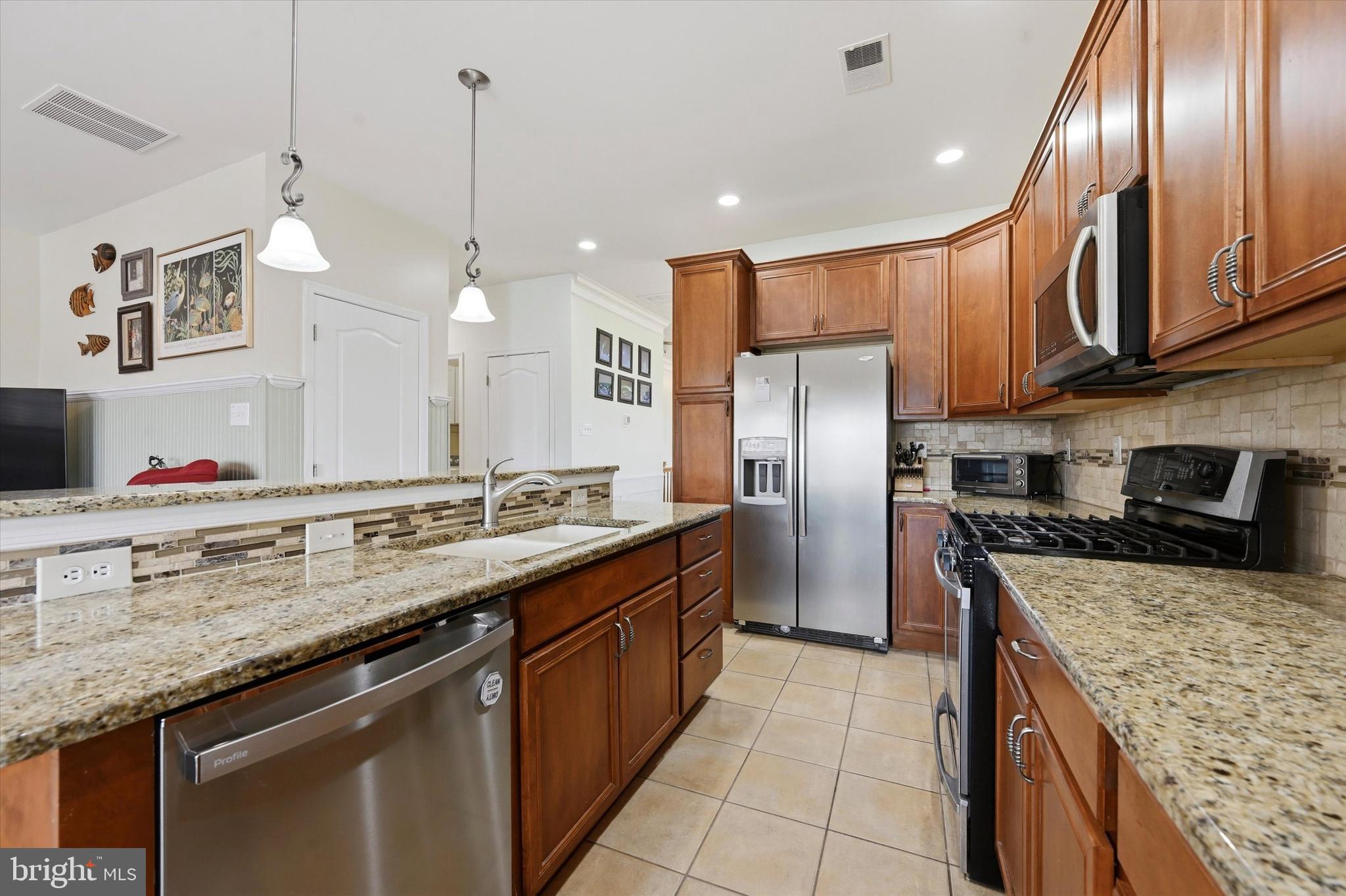 249 Stoyer Road Coatesville, PA 19320 - Photo 9 of 25 a kitchen with stainless steel appliances granite countertop a sink a stove and a refrigerator