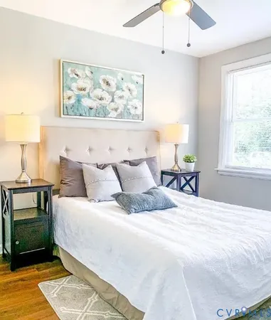 a large bed sitting in a bedroom next to a window