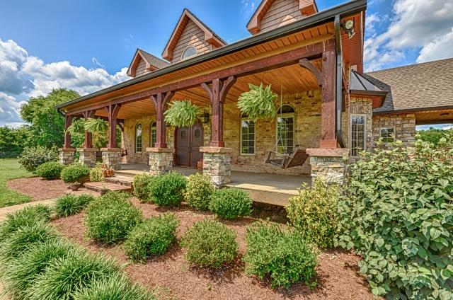 600 Bruce Road Dickson, TN 37055 - Photo 1 of 20 The home offers 1,200 square feet of outdoor porch space, including this lovely covered front porch. The centerpiece of the front porch is the stunning custom-built Brazilian walnut front door, gracefully arched to create a welcoming impression.
