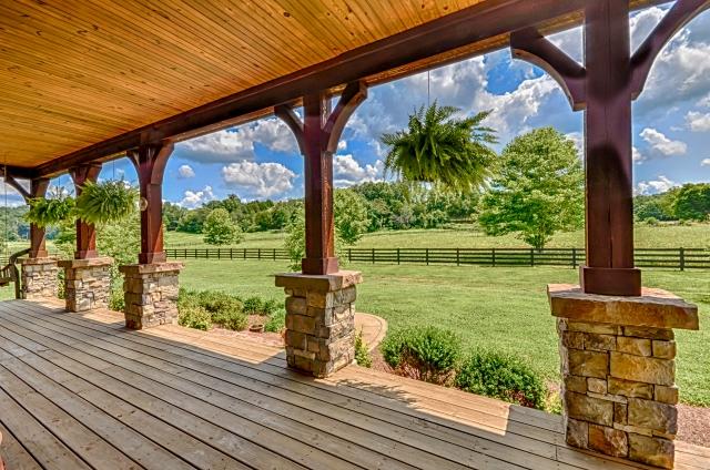 600 Bruce Road Dickson, TN 37055 - Photo 3 of 20 Front porch design details include a tongue & groove ceiling, Western cedar beams supported by custom-cut limestone copings atop stone columns, and custom-cut limestone front steps. Note the 4-rail treated pine farm fence enclosing the huge pasture.