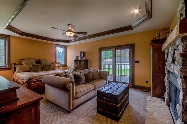 600 Bruce Road Dickson, TN 37055 - Photo 10 of 20 Located on the main level, the magnificent master suite enjoys an all-stone gas fireplace with hand-hewn wood mantel, like-new textured berber carpeting, a tray ceiling with ceiling fan light, and a huge walk-in closet with custom built-in shelving.