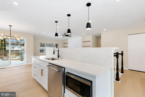 a view of a kitchen with furniture and wooden floor