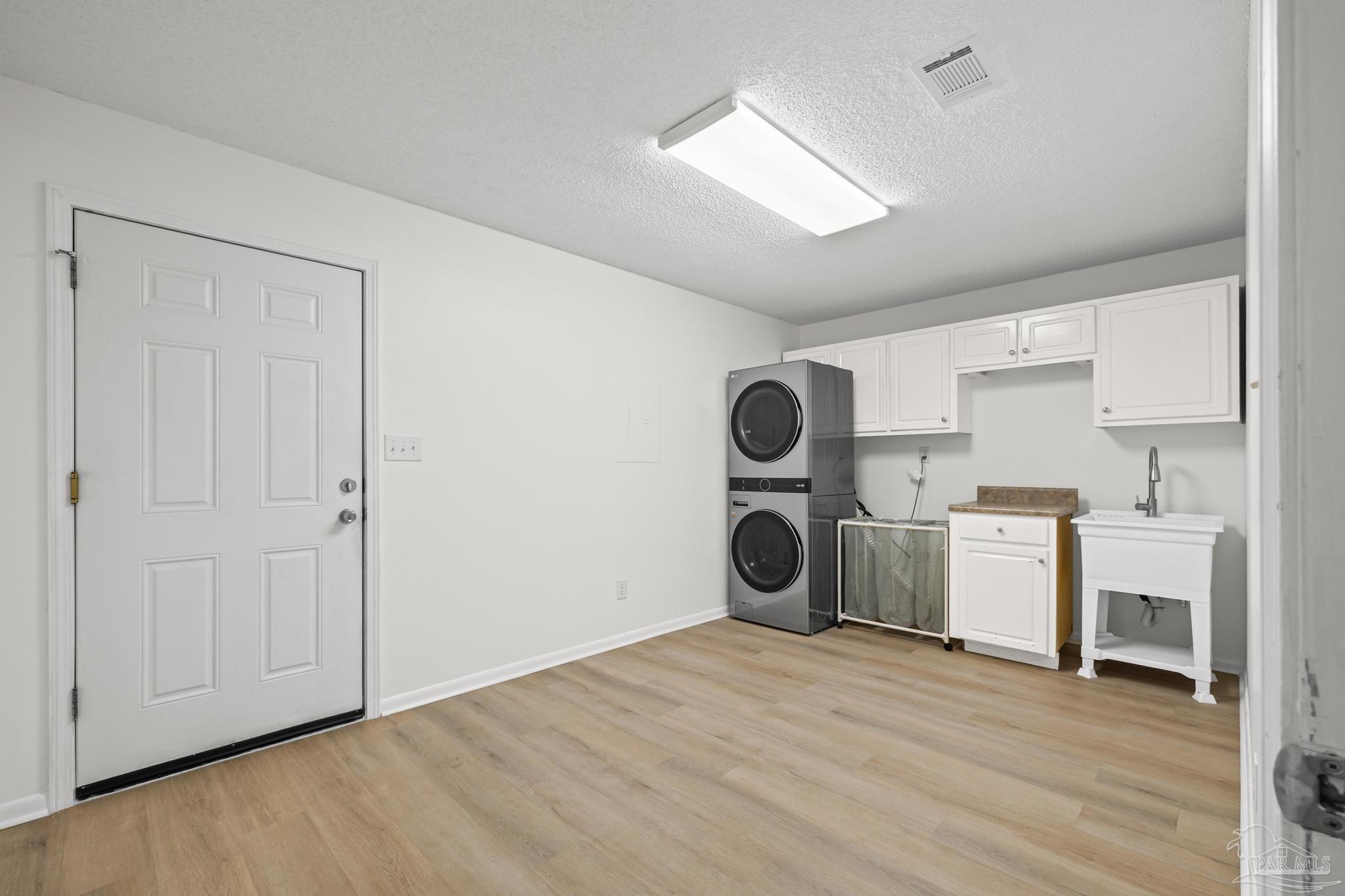 1747 New Hope Road Gulf Breeze, FL 32563 - Photo 13 of 52 laundry, cabinetry, utility sink, closet