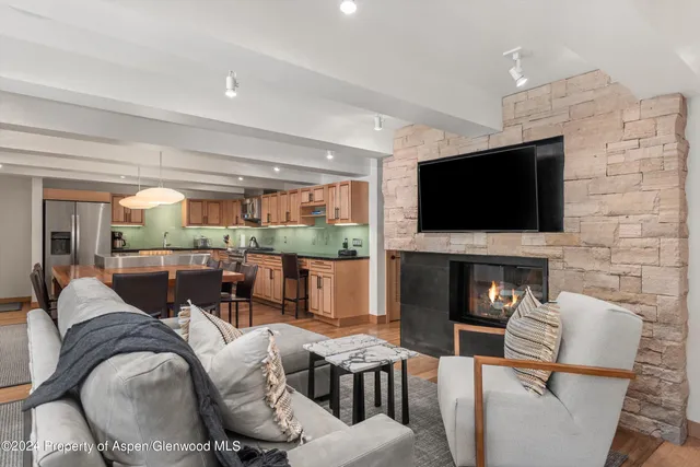 a living room with furniture and a flat screen tv
