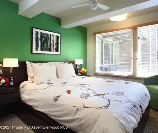 a large white bed in a small room