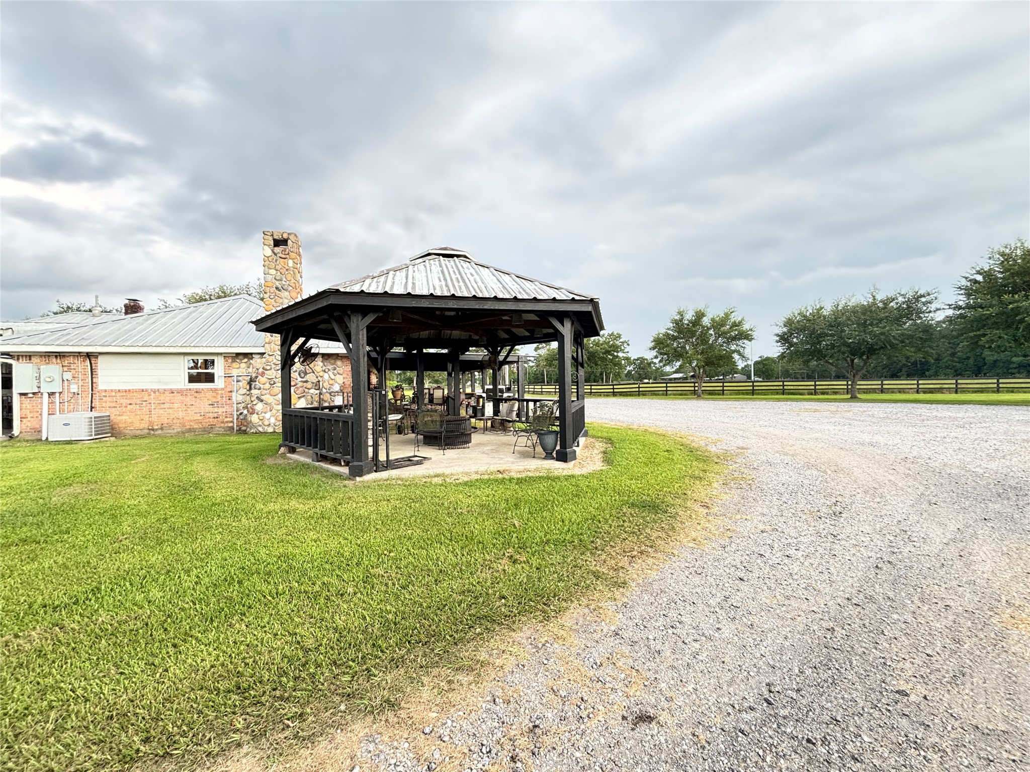 40062 Highway 105 Batson, TX 77519 - Photo 12 of 30 a view of a swimming pool with a yard in the back