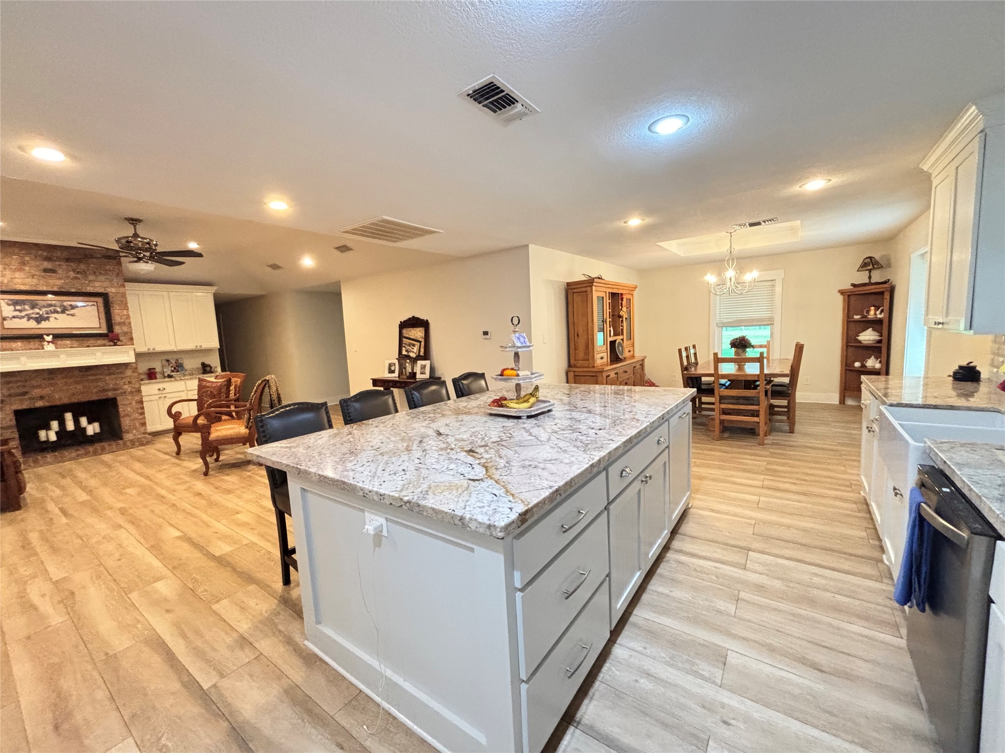 40062 Highway 105 Batson, TX 77519 - Photo 24 of 30 a large kitchen with kitchen island a stove a sink a dining table and chairs