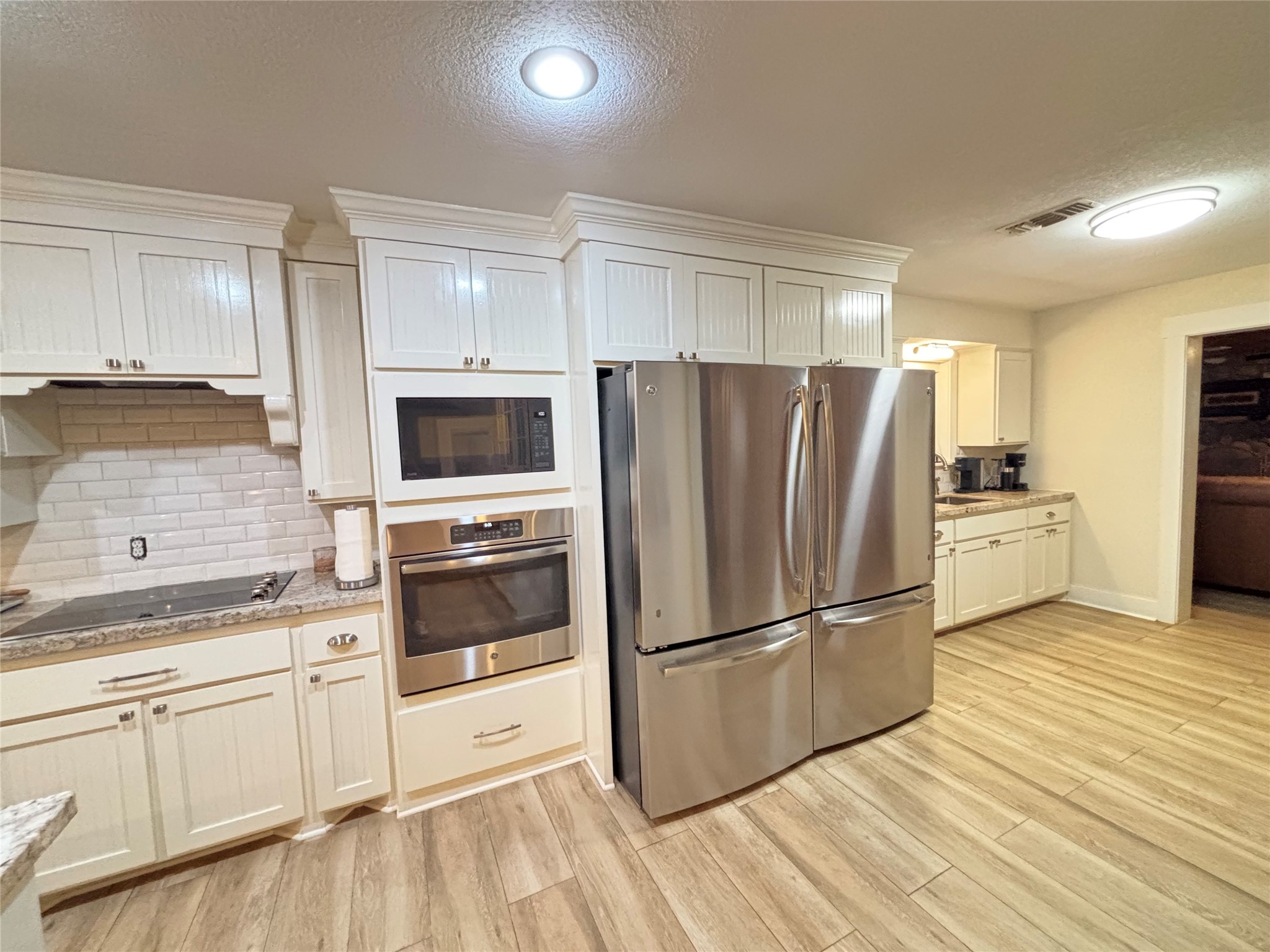 40062 Highway 105 Batson, TX 77519 - Photo 26 of 30 a kitchen with granite countertop a refrigerator stove and sink