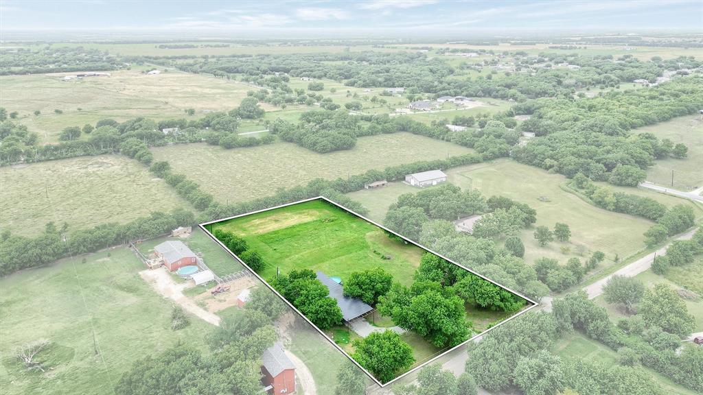 Aerial view of sparsely populated area featuring property parcel outlined