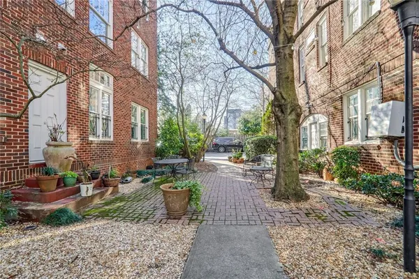 a row of houses with yard and trees