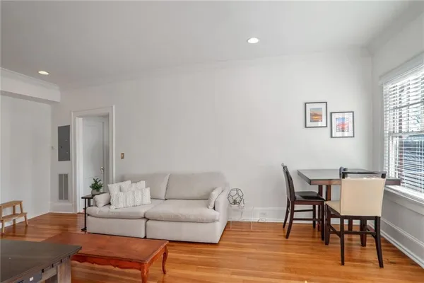 a living room with furniture wooden floor and dining table