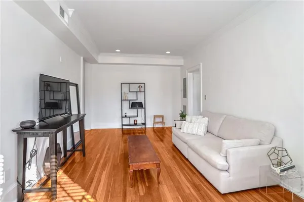 a living room with furniture and a book shelf