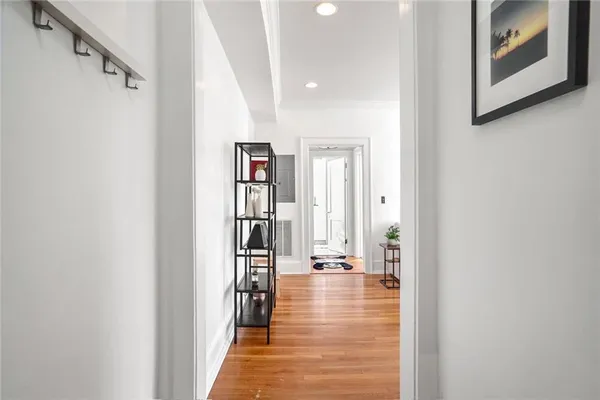 a view of a hallway with wooden floor and staircase