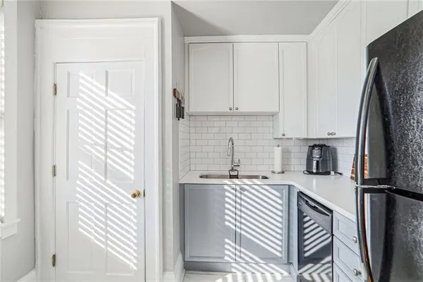 a kitchen with stainless steel appliances granite countertop a refrigerator and a sink