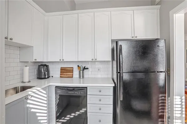a kitchen with refrigerator and cabinets